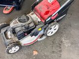 an image of a lawn mower sitting in a garage