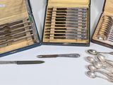 several different types of silverware are in a case on a table