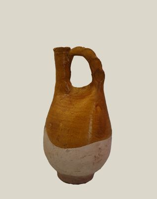 a brown and white vase with a hole in it