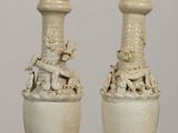 two vases that are sitting on a table
