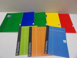 six different colored notebooks are lined up on a table