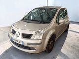 a small beige car parked in a parking lot