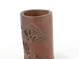 a small wooden cup with a design on it