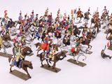 a lot of figurines of people riding horses and horses