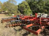 an image of a farm equipment that is in the grass