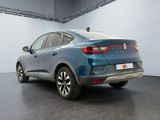 the rear end of a blue car parked in a garage