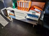 many folders on a desk with a chair in the background