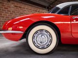 an image of a red and white car parked in a garage