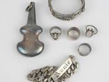 an assortment of silver jewelry including rings, bracelets, and rings