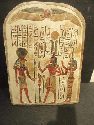 an egyptian painted plaque depicting a group of egyptian men and women