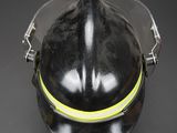 a close up of a fireman ' s helmet with goggles on a black background
