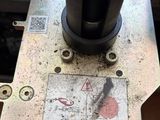 a close up of a machine that is working on a piece of metal