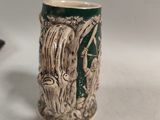 a green and white mug with a picture of a man and a woman