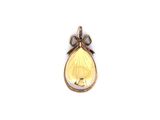 a close up of a yellow and white butterfly pendant on a white background