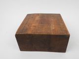 a close up of a wooden box on a white surface