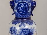 a blue and white vase sitting on a table