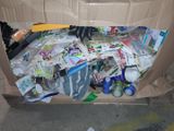 a cardboard box filled with assorted items sitting on the floor