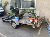 a small trailer with a tractor on the back of it