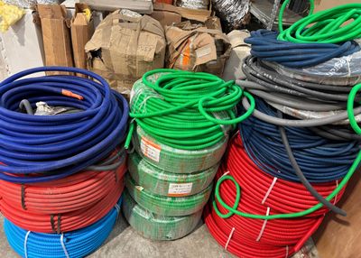a lot of different colored hoses stacked on top of each other