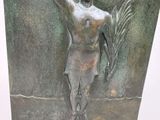 a bronze statue of a man holding a fish