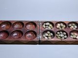 two wooden trays filled with eggs on top of a table