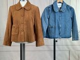 pair of jackets on a stand in front of a white wall