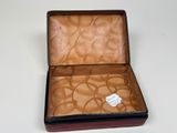 an open suitcase with a tag on it on a table