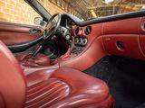 the interior of a car with red leather seats and a steering wheel