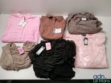 a lot of clothes that are sitting on a table