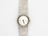 a close up of a watch on a white surface with a white background