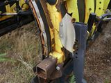 a tractor that is sitting in the grass next to a truck