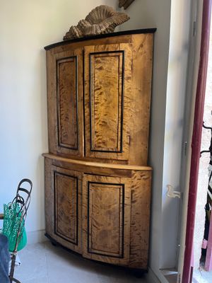 a large wooden cabinet in the corner of a room