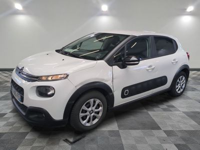 the white citrole is parked in the garage on a checkered floor