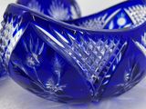 pair of cobalt blue glass bowls on a white surface