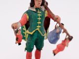 a figurine of a man with a hat and a bag