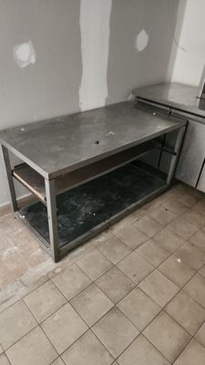 a kitchen with a table and a stove in it