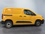 the yellow van is parked in a large room with a gray floor