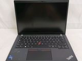 the laptop is open on a white surface with a black keyboard
