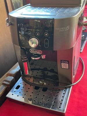 a coffee machine that is sitting on a red table