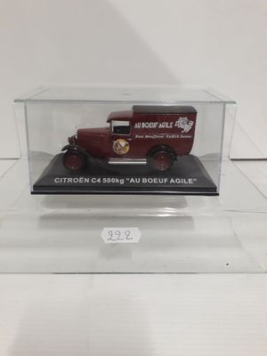 an old model of a red truck in a clear case