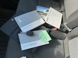 a car seat with a bunch of papers on the back of it