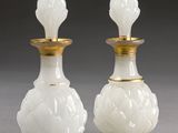 paire de vases en verre blanc aux bords dorés sur fond gris