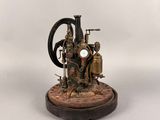 statue of a steam engine on a wooden base on a white background