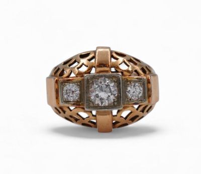 a close up of a gold and diamond ring on a white background