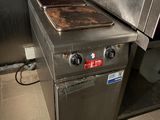a stove that is sitting in the middle of a kitchen