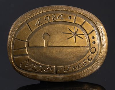 une image représentant une pièce d'or sur laquelle figure un soleil