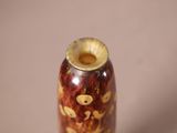a vase that has a brown and yellow design on it