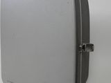 a gray suitcase sitting on a white surface