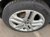 a close up of a tire on a car in a parking lot