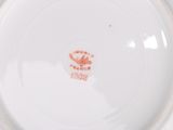 a close up of a plate with a bird on it